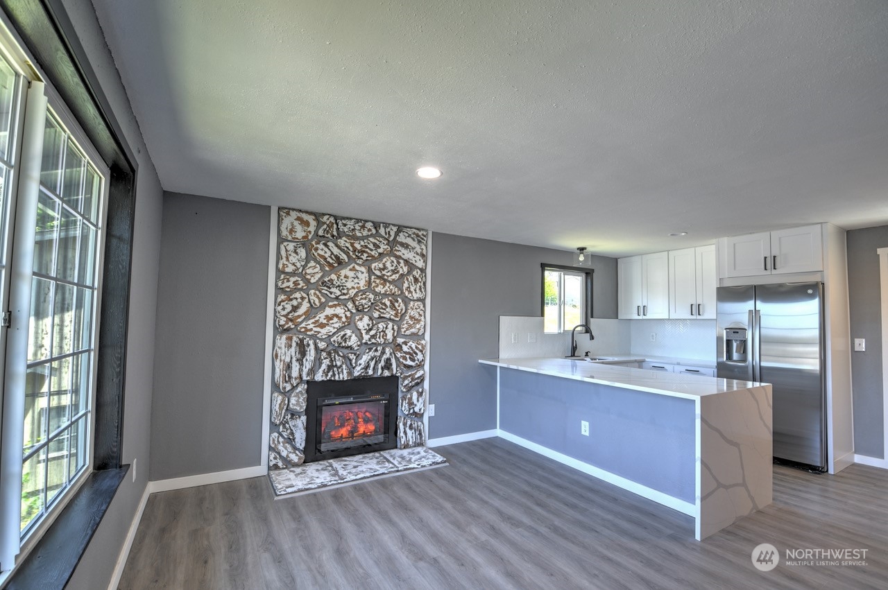 3583 East R Street Tacoma, WA 98404 - Photo 5 of 29 a view of kitchen with wooden floor and a fireplace