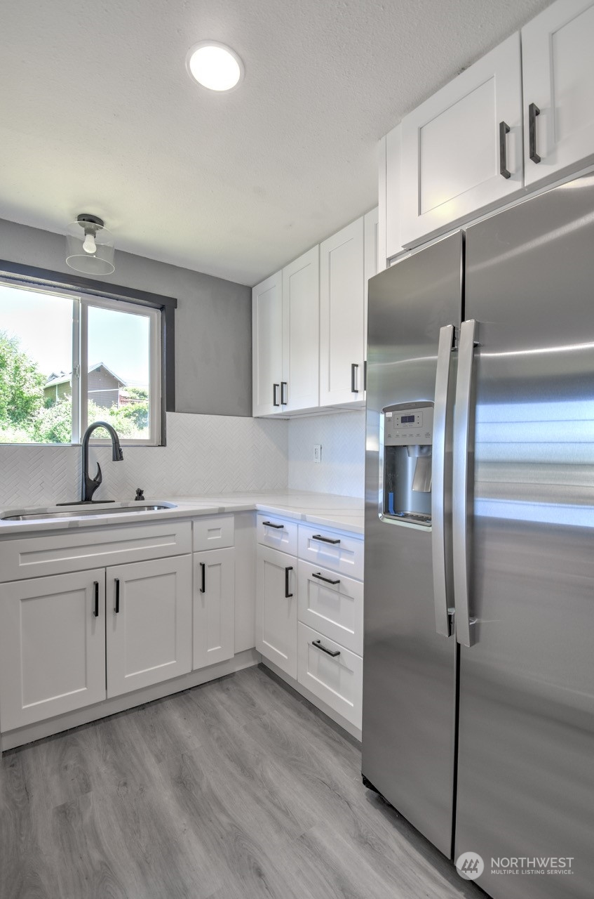 3583 East R Street Tacoma, WA 98404 - Photo 8 of 29 a kitchen with appliances cabinets and a sink