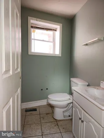 a bathroom with a toilet sink and window