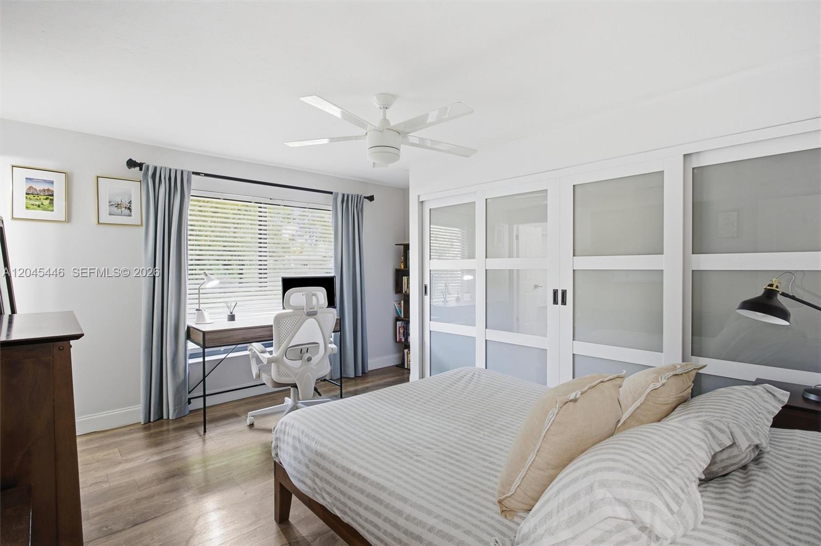 8440 Southwest 180th Street Palmetto Bay, FL 33157 - Photo 30 of 54 a bedroom with a bed and a large window with chair