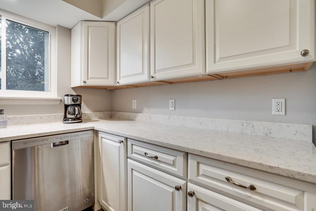 11041 Saffold Way Reston, VA 20190 - Photo 11 of 44 a kitchen with granite countertop white cabinets and a white counter top