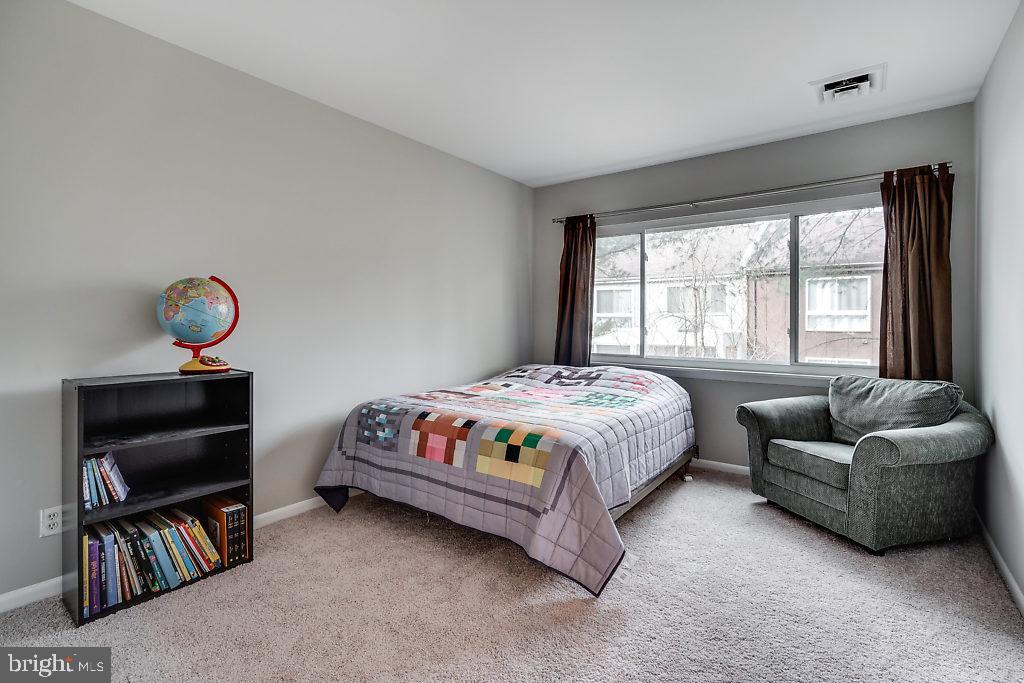 11041 Saffold Way Reston, VA 20190 - Photo 19 of 44 a bedroom with a bed and a book shelf