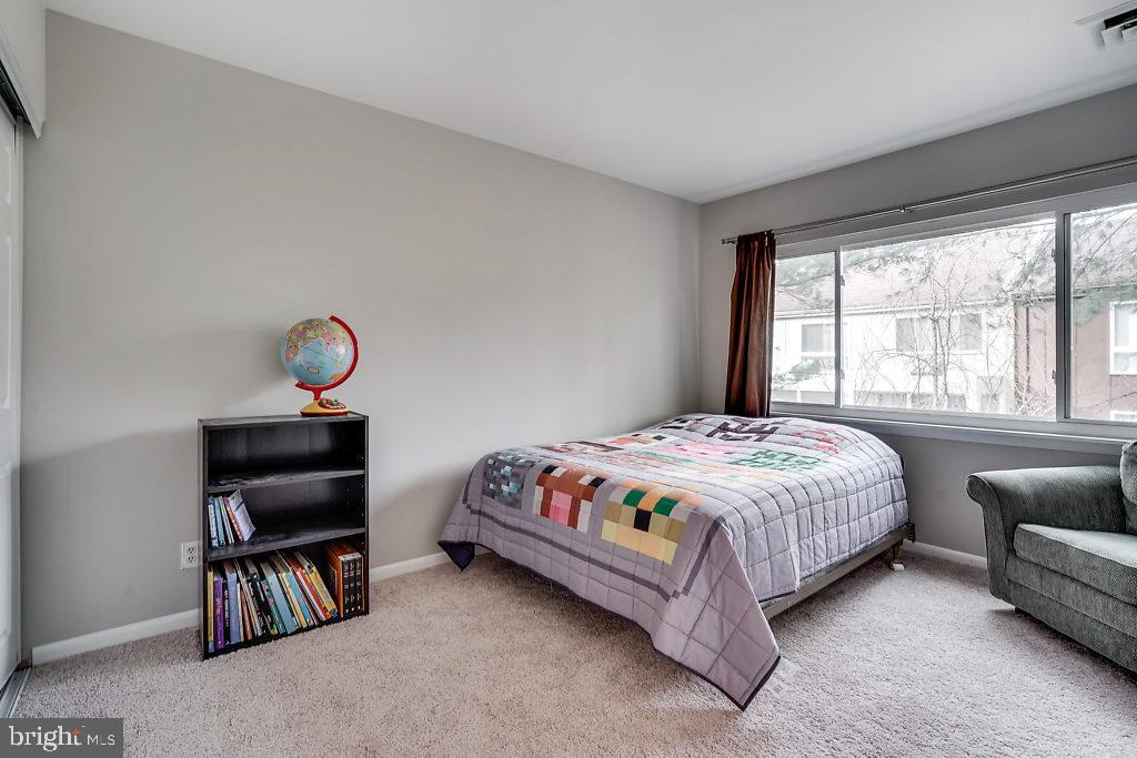 11041 Saffold Way Reston, VA 20190 - Photo 20 of 44 a bedroom with a bed and a large window