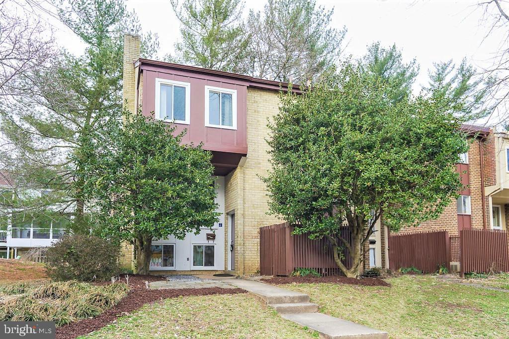 11041 Saffold Way Reston, VA 20190 - Photo 3 of 44 a front view of a house with garden