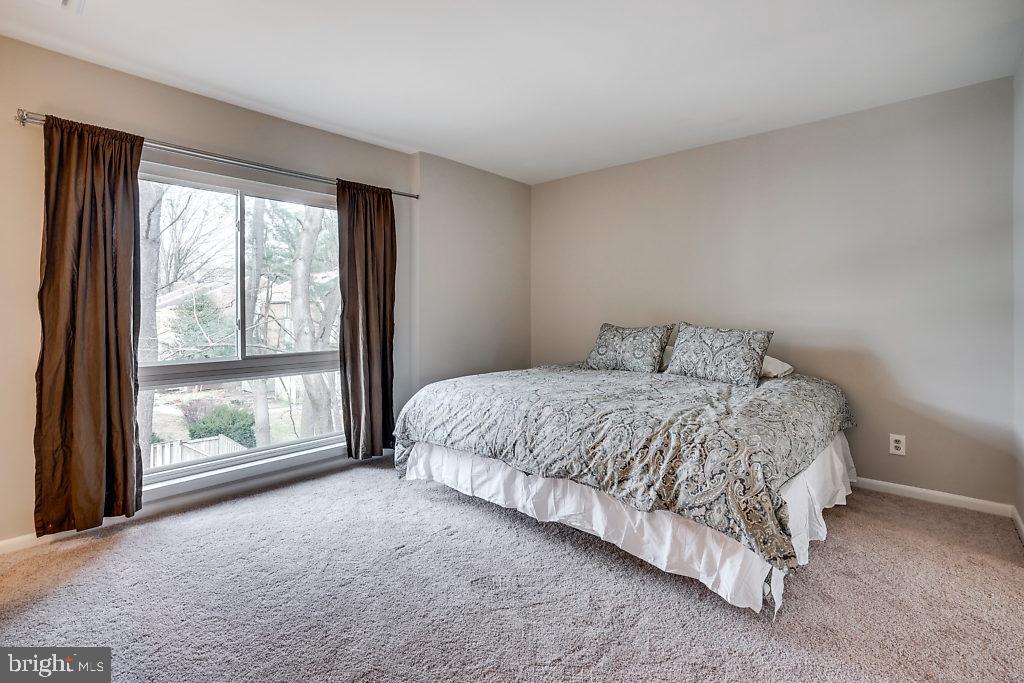 11041 Saffold Way Reston, VA 20190 - Photo 21 of 44 a bed sitting in a bedroom next to a window