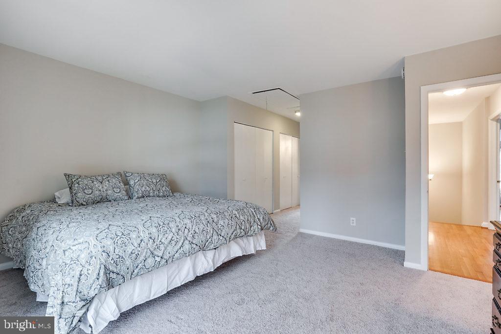 11041 Saffold Way Reston, VA 20190 - Photo 23 of 44 a bedroom with a bed and a night stand