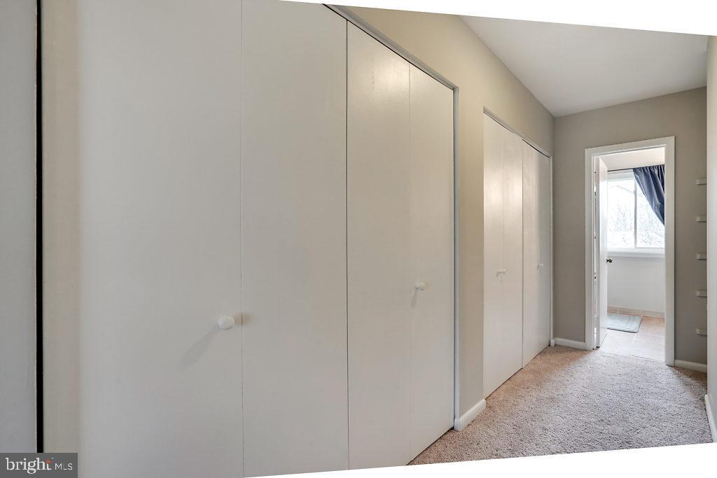 11041 Saffold Way Reston, VA 20190 - Photo 24 of 44 a view of a hallway with wooden floor