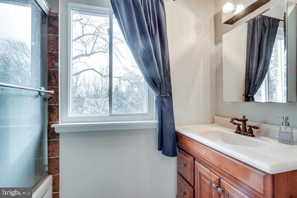 11041 Saffold Way Reston, VA 20190 - Photo 25 of 44 a bathroom with a sink window and a mirror