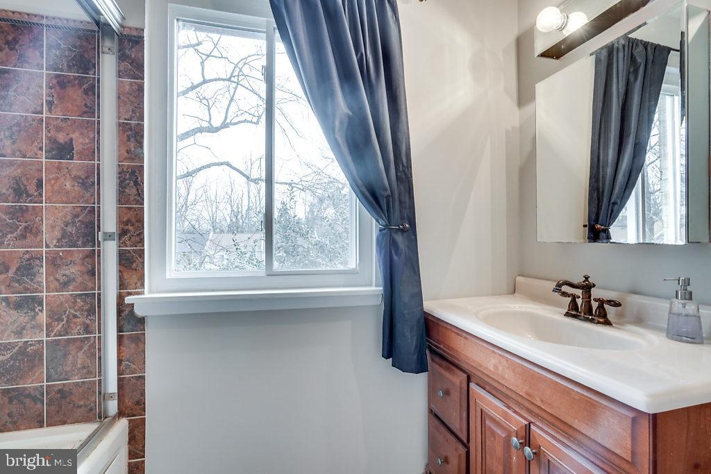 11041 Saffold Way Reston, VA 20190 - Photo 26 of 44 a bathroom with a sink window and a mirror