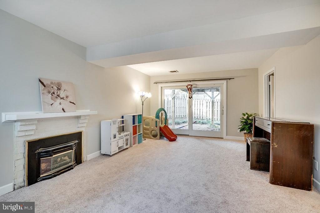 11041 Saffold Way Reston, VA 20190 - Photo 29 of 44 a view of a livingroom with furniture a fireplace and windows