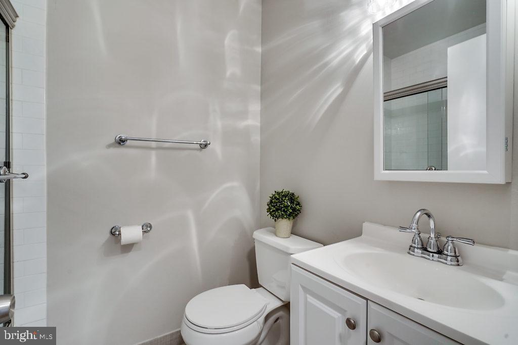 11041 Saffold Way Reston, VA 20190 - Photo 36 of 44 a bathroom with a sink mirror vanity and toilet