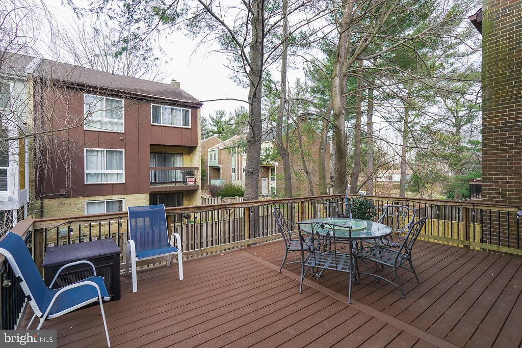 11041 Saffold Way Reston, VA 20190 - Photo 38 of 44 a view of a roof deck with table and chairs and wooden floor