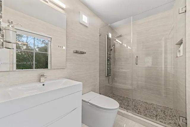 a bathroom with a sink toilet and shower