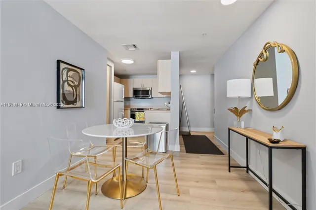 a view of a dining room with furniture and a mirror