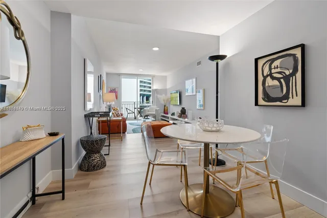 a view of a dining room with furniture and a potted plant