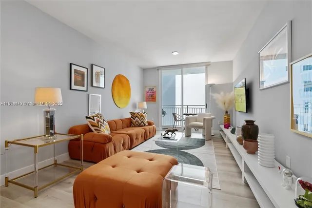 a living room with fireplace furniture and a window