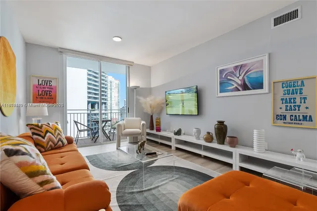 a living room with furniture a rug and a window