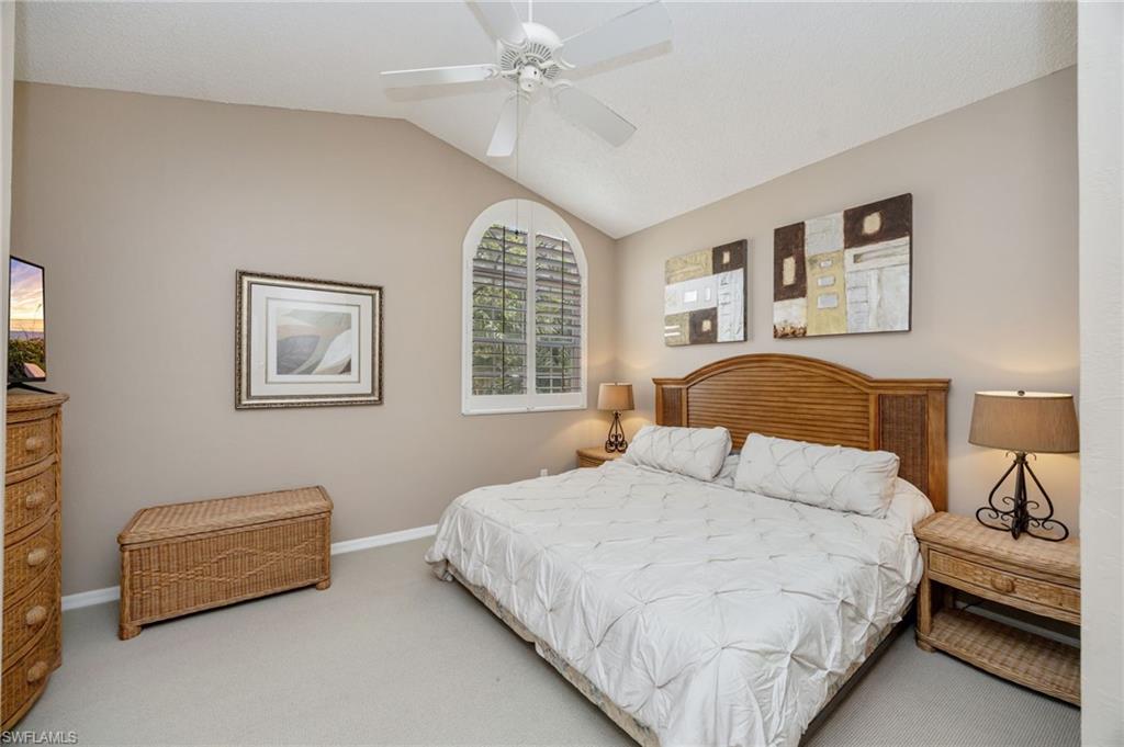 89 Silver Oaks Circle, Unit 5201 Naples, FL 34119 - Photo 11 of 21 a bedroom with a bed and a couch