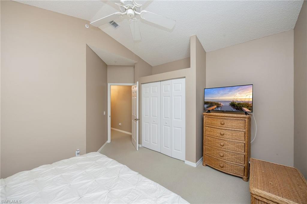 89 Silver Oaks Circle, Unit 5201 Naples, FL 34119 - Photo 12 of 21 a bedroom with a bed and a dresser