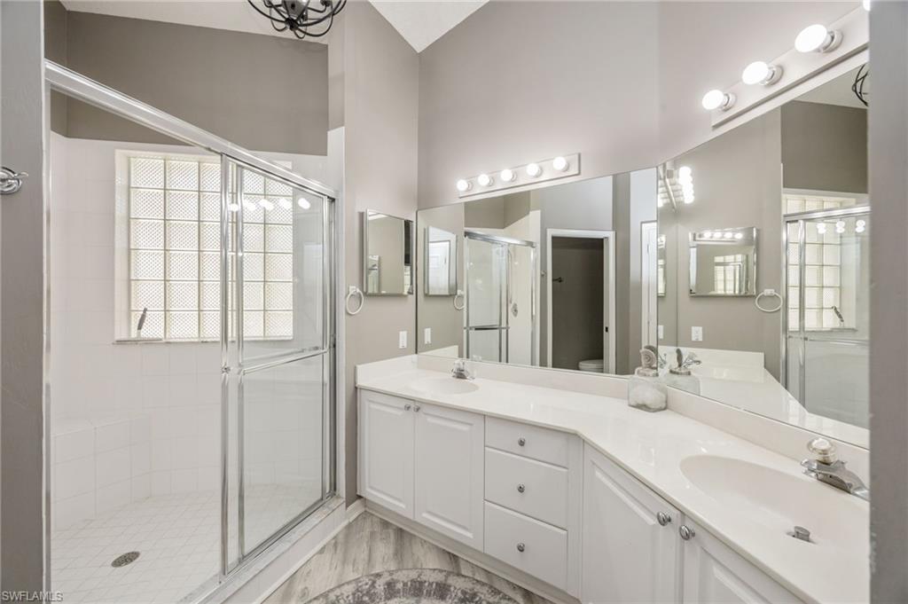 89 Silver Oaks Circle, Unit 5201 Naples, FL 34119 - Photo 13 of 21 a bathroom with a double vanity sink mirror and double
