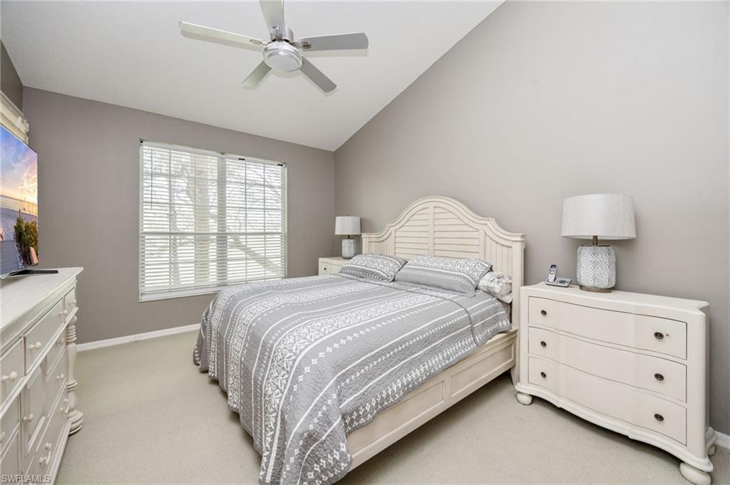 89 Silver Oaks Circle, Unit 5201 Naples, FL 34119 - Photo 15 of 21 a bed room with a bed and a night stand