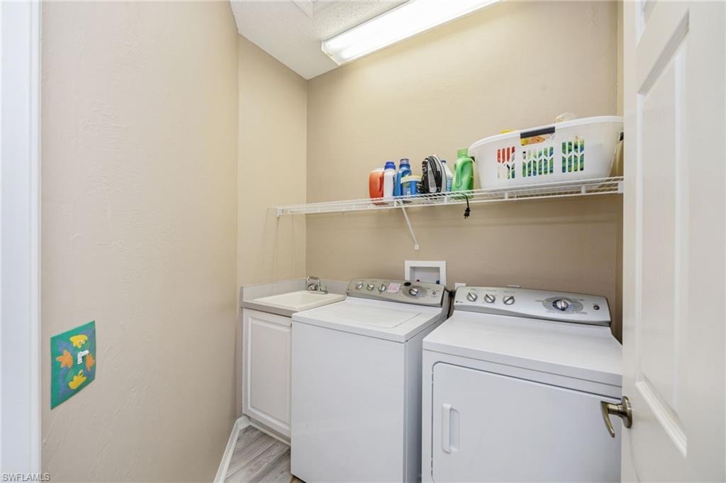 89 Silver Oaks Circle, Unit 5201 Naples, FL 34119 - Photo 19 of 21 a utility room with dryer and washer