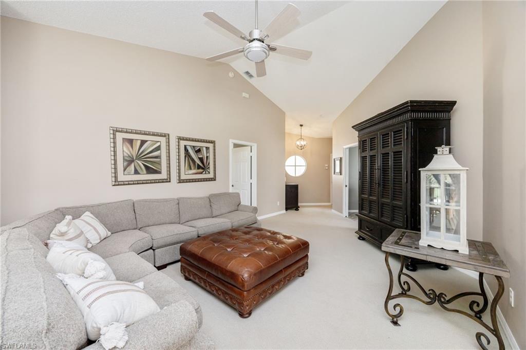 89 Silver Oaks Circle, Unit 5201 Naples, FL 34119 - Photo 8 of 21 a living room with furniture and a chandelier