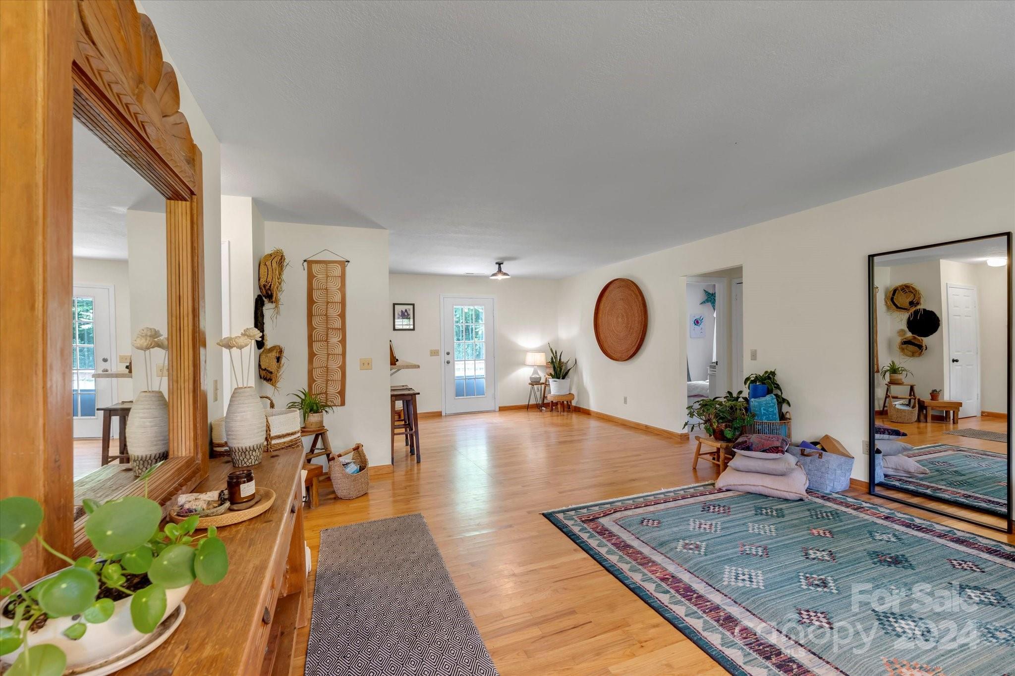 634 Dillingham Road, Unit B Barnardsville, NC 28709 - Photo 13 of 32 a living room with dining room and wooden floor