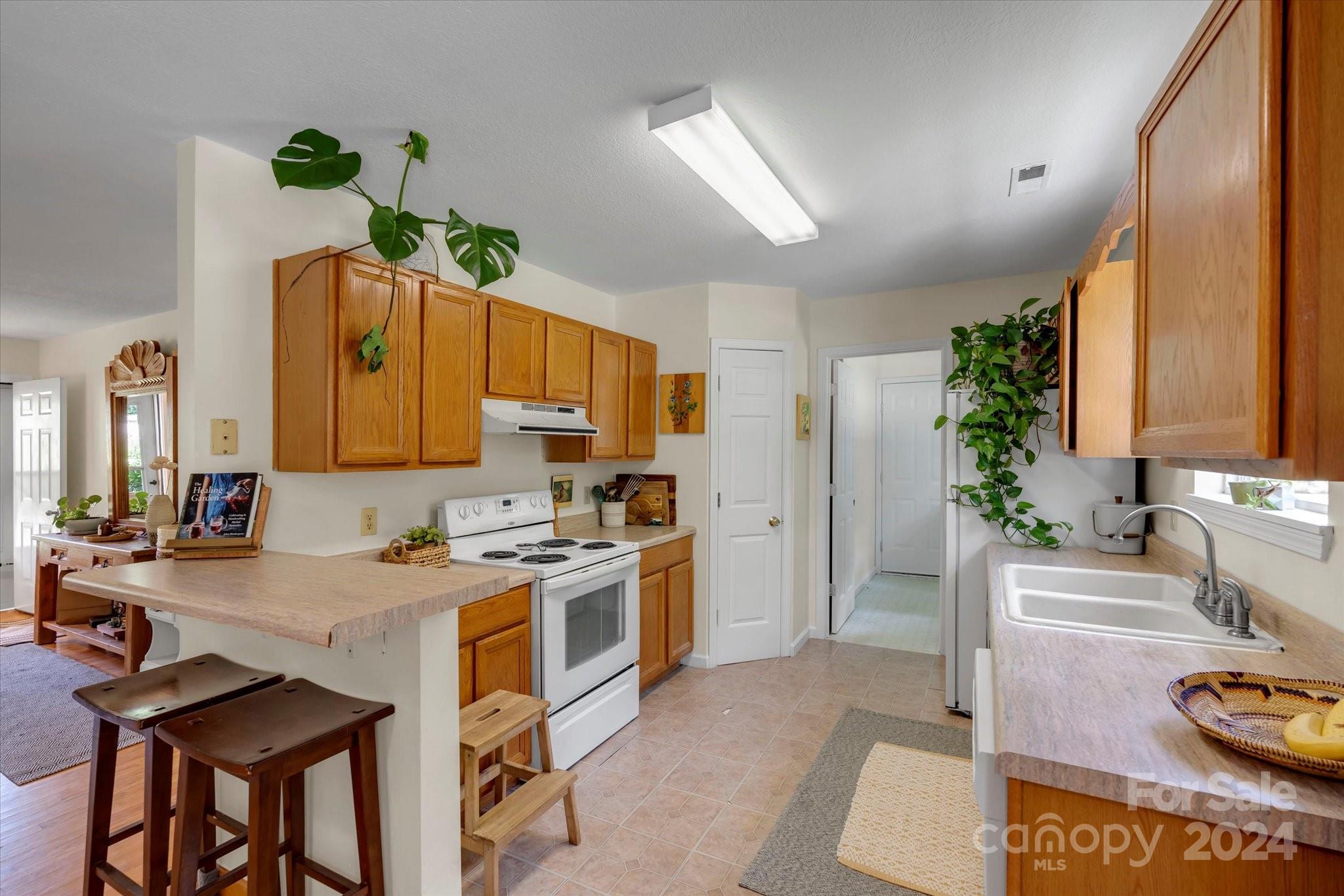 634 Dillingham Road, Unit B Barnardsville, NC 28709 - Photo 16 of 32 a kitchen with stainless steel appliances granite countertop a sink stove and cabinets