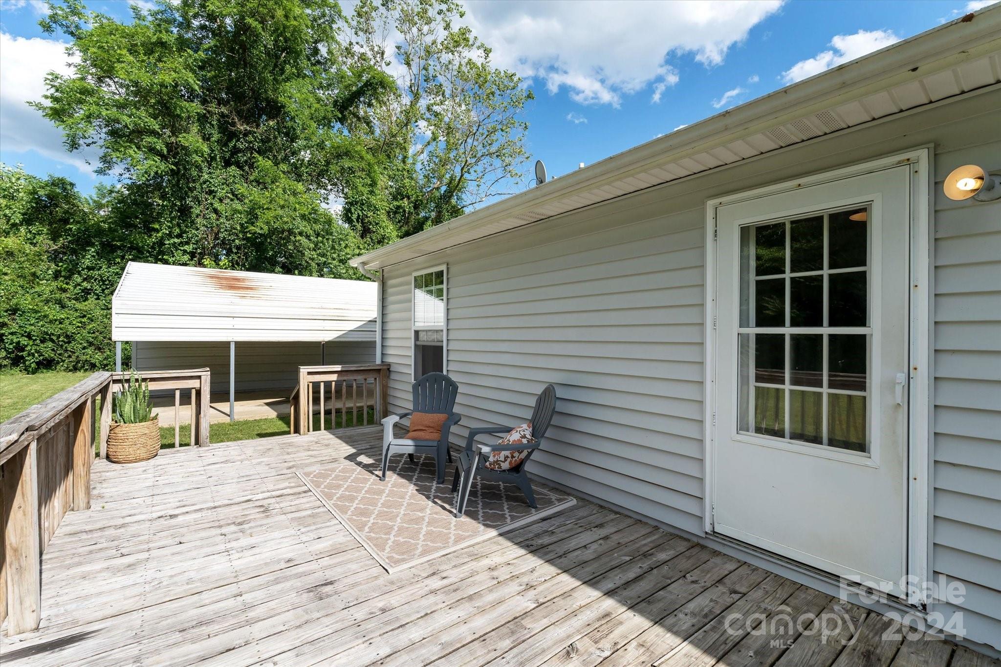 634 Dillingham Road, Unit B Barnardsville, NC 28709 - Photo 28 of 32 a view of a patio with table and chairs with wooden floor and fence