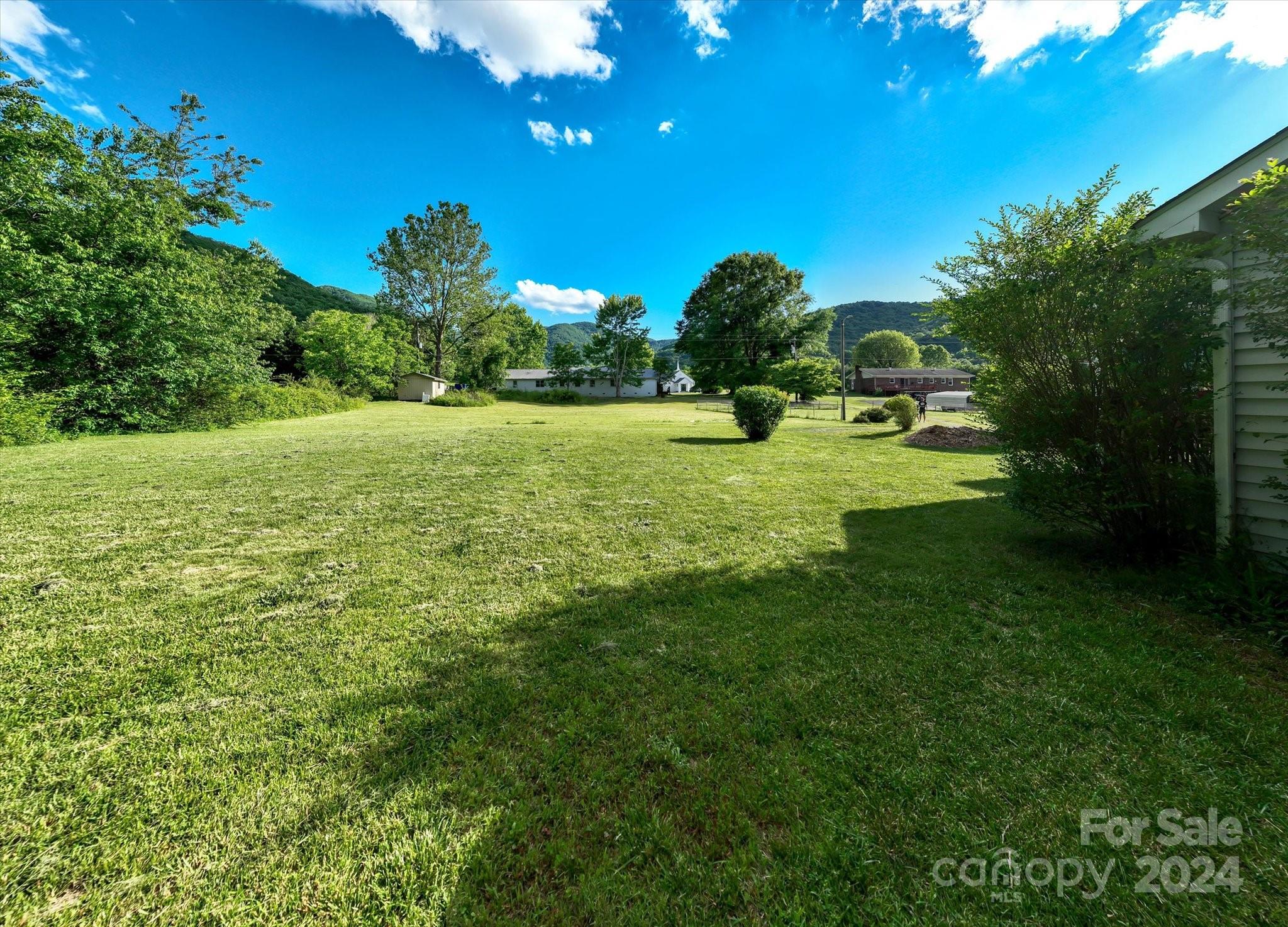 634 Dillingham Road, Unit B Barnardsville, NC 28709 - Photo 8 of 32 a backyard of a house with a garden
