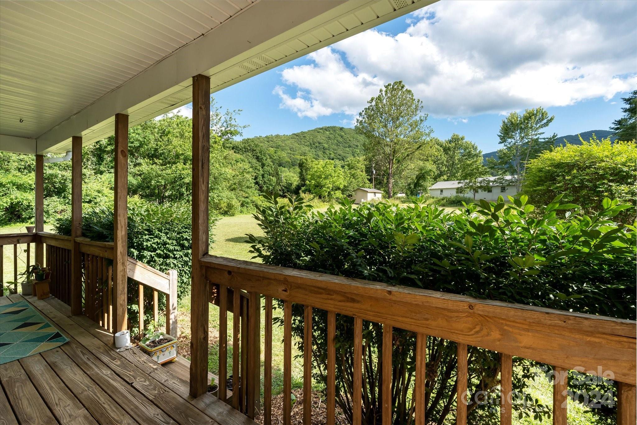 634 Dillingham Road, Unit B Barnardsville, NC 28709 - Photo 9 of 32 a balcony with trees in front of it