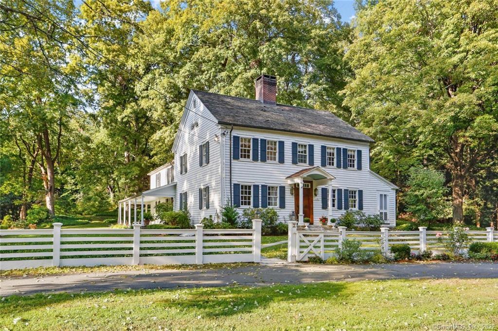 3 Great Pasture Road Redding, CT 06896 - Photo 1 of 1 a front view of a house with a yard table and chairs