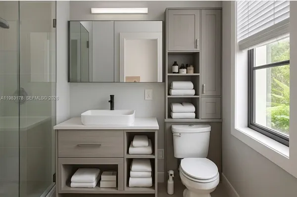 a bathroom with a toilet a sink and a window