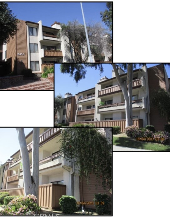 a front view of a building with streets and trees