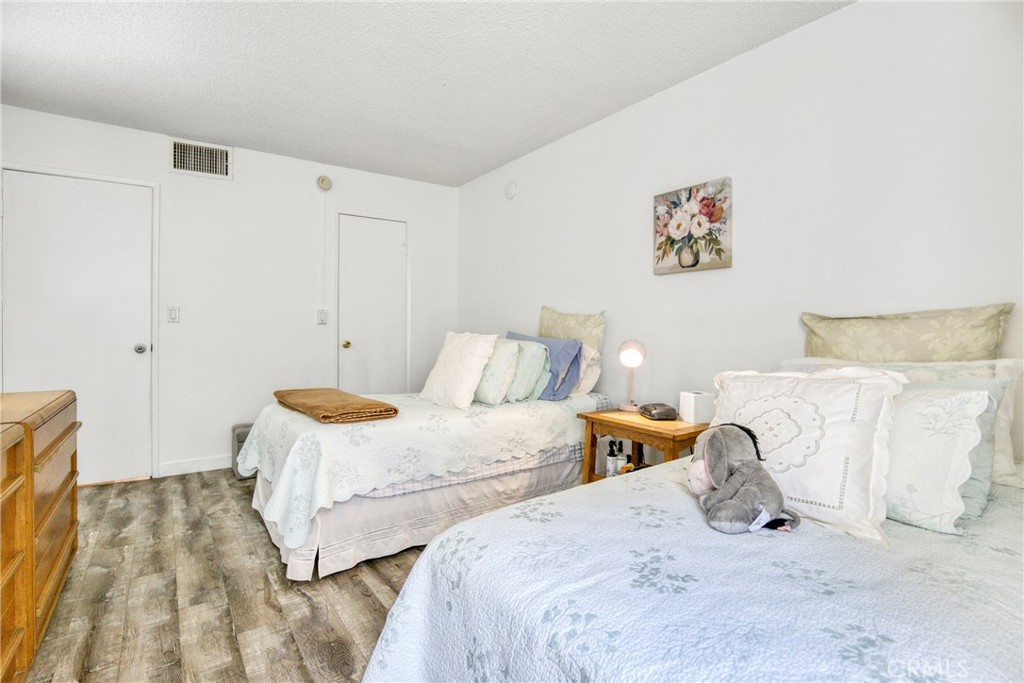 15155 Sherman Way, Unit 14 Van Nuys, CA 91405 - Photo 19 of 36 a bedroom with two beds and a lamp