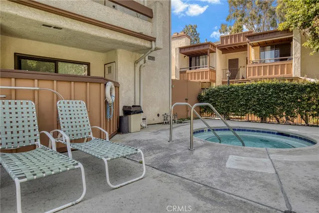 a view of a backyard with swimming pool