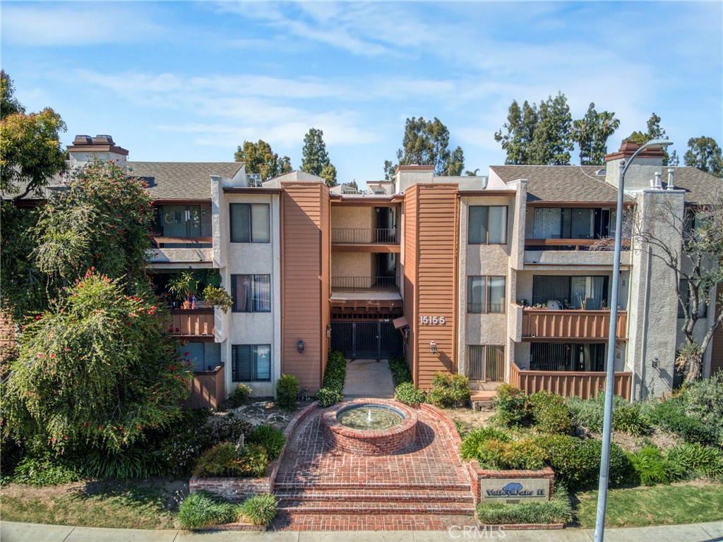 15155 Sherman Way, Unit 14 Van Nuys, CA 91405 - Photo 4 of 36 a front view of a house with a yard and balcony