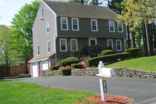 a front view of a house with a yard and outdoor seating