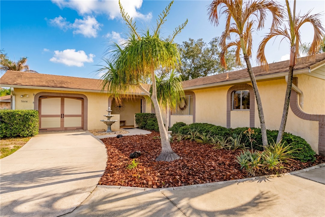 7666 134th Street Sebastian, FL 32958 - Photo 32 of 35 a front view of a house with garden