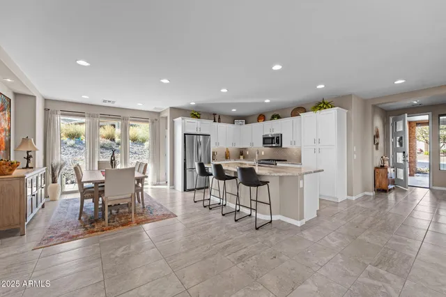 a kitchen with stainless steel appliances granite countertop a sink and a refrigerator