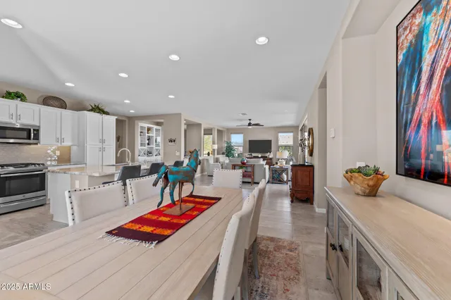 a spacious bathroom with a granite countertop sink a toilet a mirror and vanity