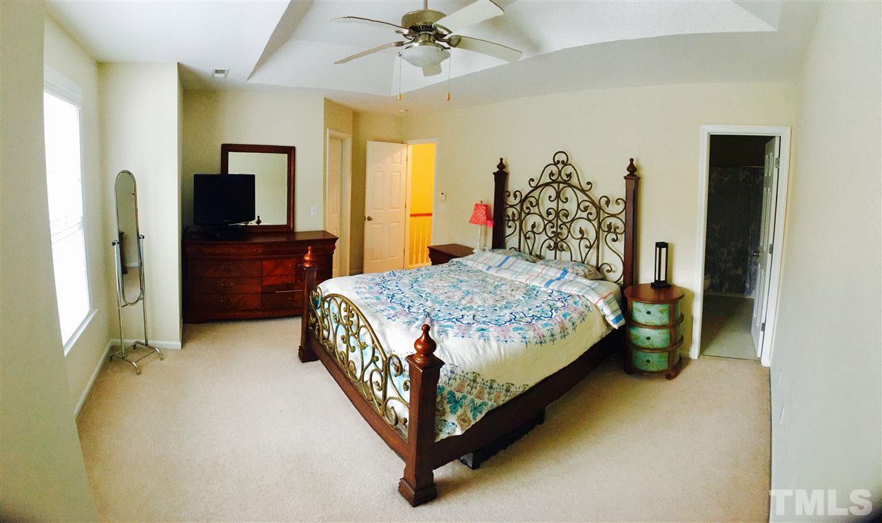 4433 Moss Garden Path Raleigh, NC 27616 - Photo 12 of 20 a bedroom with a bed and a dresser in it