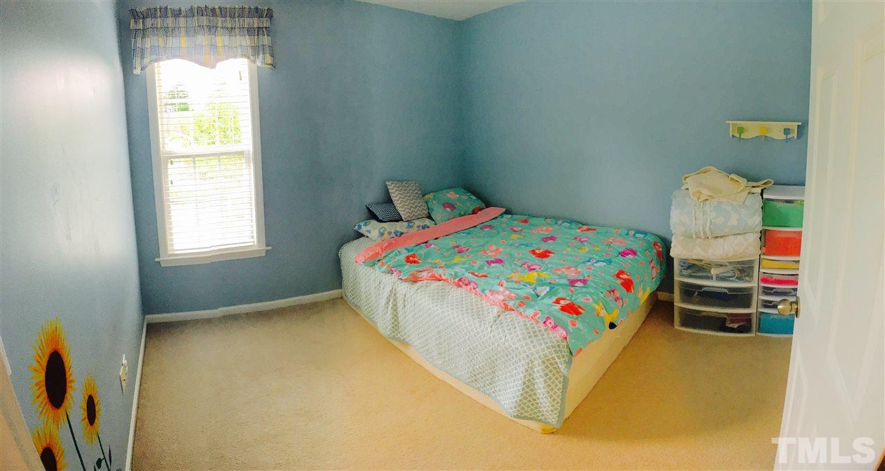 4433 Moss Garden Path Raleigh, NC 27616 - Photo 15 of 20 a bedroom with a bed and a window