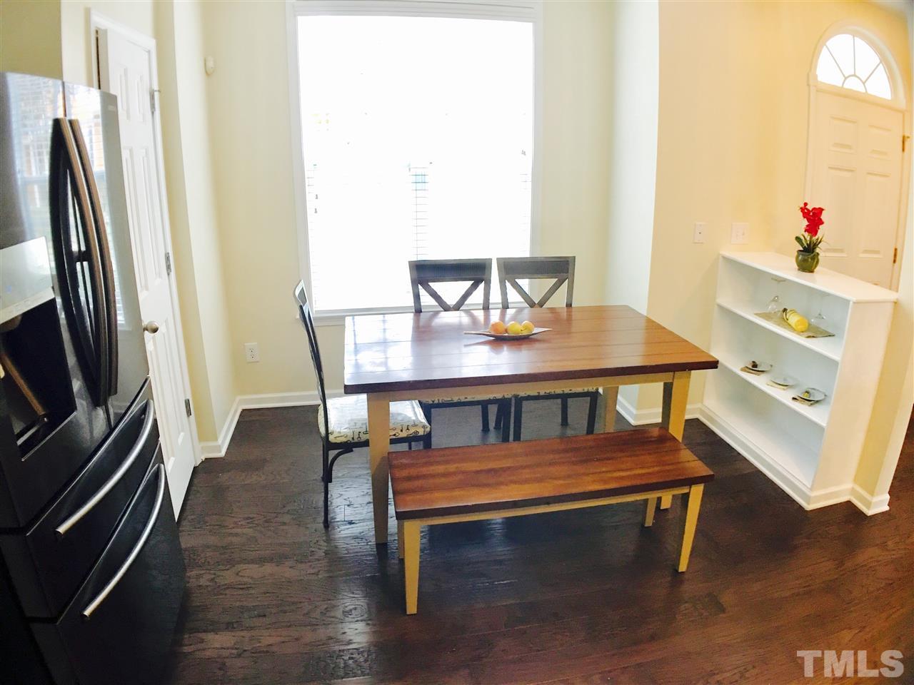 4433 Moss Garden Path Raleigh, NC 27616 - Photo 6 of 20 a view of a dining room with furniture window and wooden floor