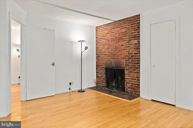 a view of empty room with a fireplace