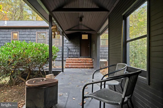 a front view of a house with outdoor seating
