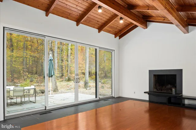 a view of an empty room with window and fire place