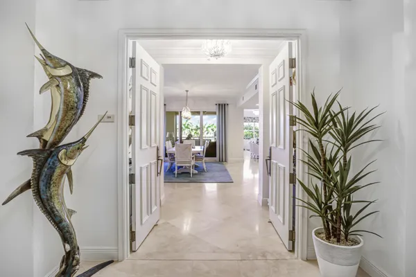 a view of a hallway with furniture and floor to ceiling window