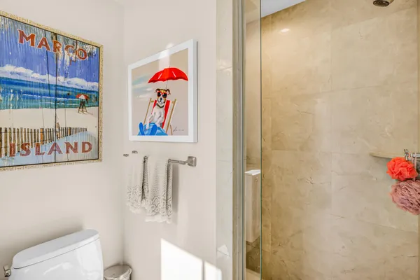 a bathroom with a toilet and a shower curtain